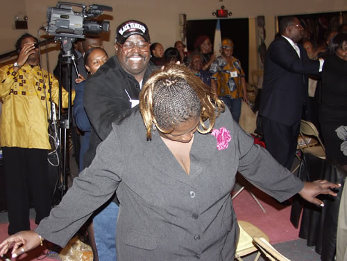Audience doing group massage exercise, New York City Black Business Seminar